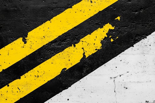 A black and yellow striped wall with a yellow stripe photo