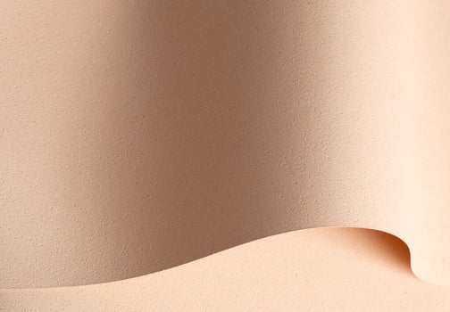 Elegant designer paper in beige and cream tones with rough grained texture and pierced surface. photo