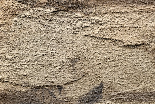 Golden textured wall with rough, grungy surface and antique pattern. Aged, weathered metal or stone photo