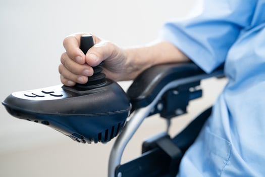senior woman patient on electric wheelchair with remote control photo
