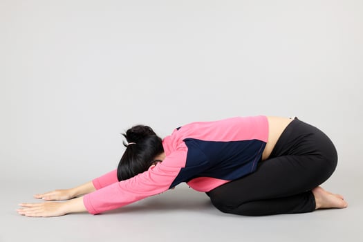 Young Woman doing Yoga Child Pose photo