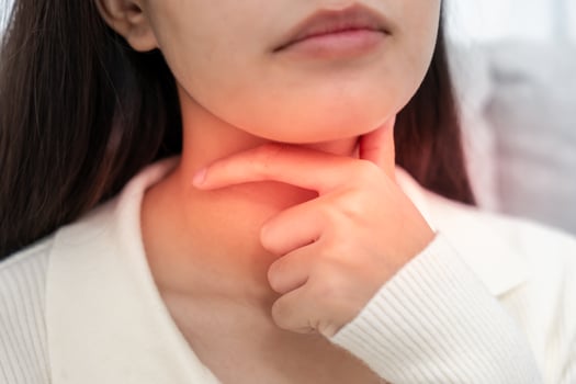 Asian woman put on neck due to a sore throat. female tonsillitis causes a inflammation. treated by taking water, taking antibiotics, consult a doctor, corona virus. photo