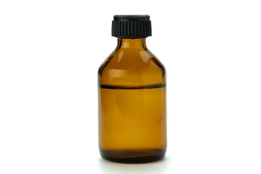 Brown glass medical bottle with liquid and black plastic cap photo