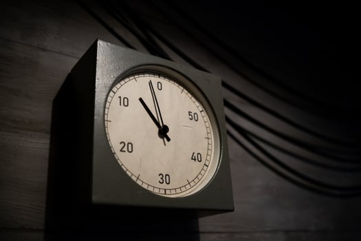 Clock Displaying Time Approaching Zero in a Dimly Lit Room Emphasizing Urgency and Anticipation During an Important Countdown photo