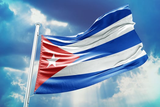 Cuba flag on blue sky background photo