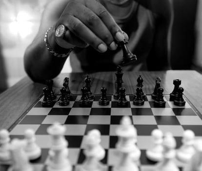 Chess Player moving the Queen photo