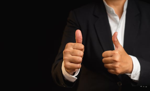 Close-up of a businessman gives the client satisfaction thumbs up for the best excellent services photo