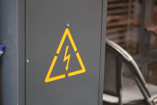 Warning sign on electrical cabinet in industrial location photo