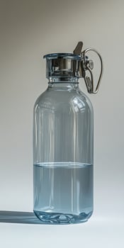 A large glass jar with a metal handle photo
