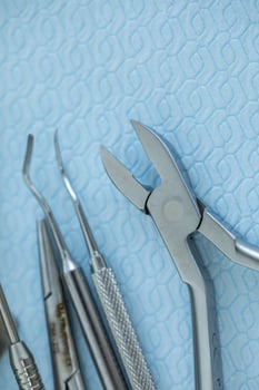 Dental tools and instruments on blue background, close-up. photo