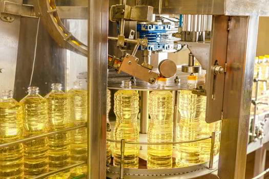 Automated Sunflower Oil Bottling Line in Modern Factory with Industrial Machinery and Transparent Bottles photo