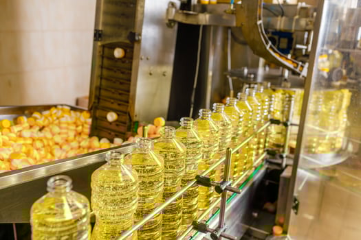 Automated Sunflower Oil Bottling Line in Modern Factory with Transparent Bottles and Industrial Equipment photo