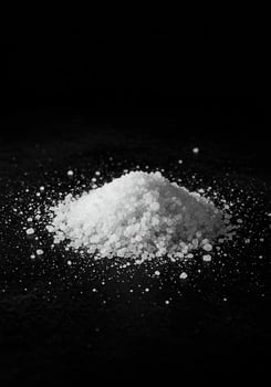 Pile of coarse salt on a dark surface photo