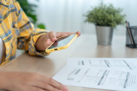 Modern female use phone to scan barcode or QR codes to pay credit card bill after receive document invoice. payment, receive, paying electricity, digital payments without money, technology, scan photo