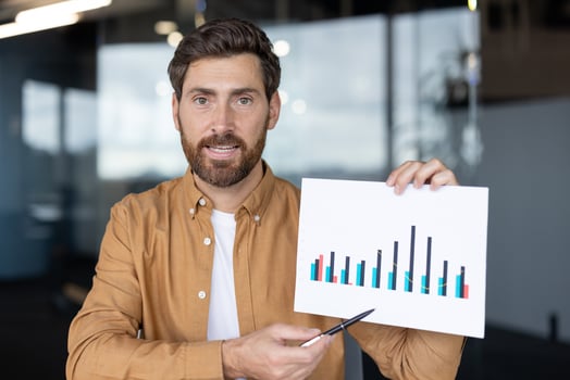 A businessman in a call presents a chart, highlighting business growth with a pen, suitable for online presentations photo