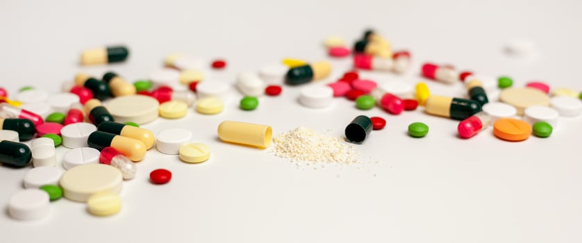 Colorful tablets and capsules on a light background. The concept of medical care. Pharmaceutical preparations for the treatment of sick patients. the banner photo