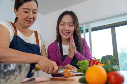 Cooking Together. Two women enjoying a fun cooking session with fresh ingredients. photo