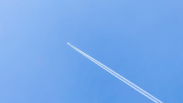 In a boundless azure canvas, a solitary jet leaves trails of whispered dreams, echoing Pilots Day and Sky Awareness Week photo