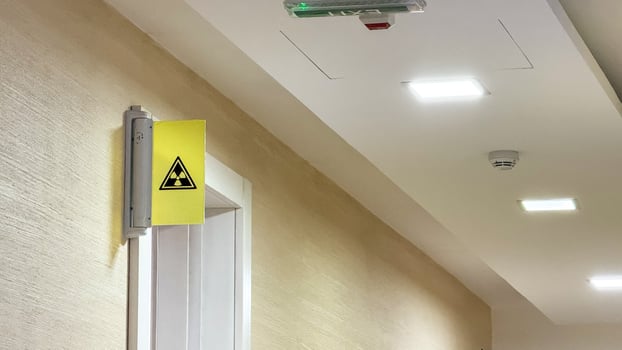 Illuminated corridor with a cryptic radiation sign, evoking Sci fi Day unease, safety protocol ambiance, secretive mystery vibe photo