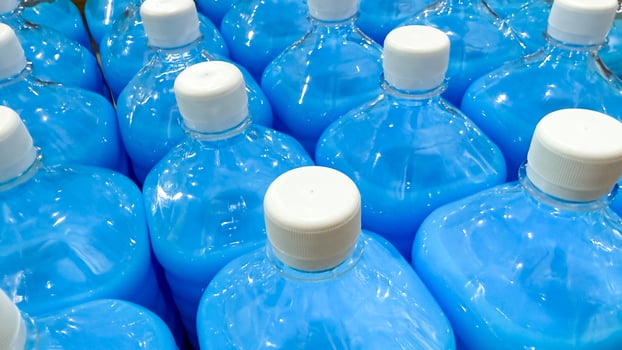 Rows of azure elixir bottles glisten, evoking alchemical mystery, vital hydration, Aqua Crystalline Festival, fluorescent fluid abundance photo