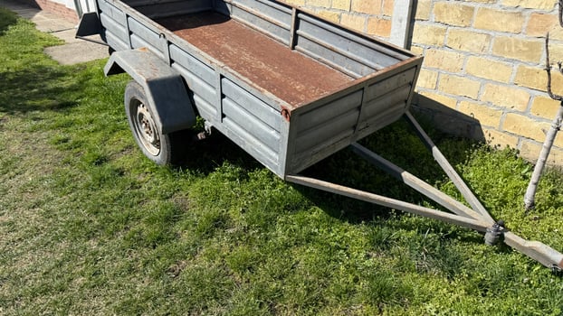 Rustic trailer basks in sunshine, whispering tales of harvest festivals and countryside escapades, embodying rural nostalgia and simplicity photo