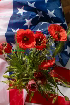 American flag cradling vibrant poppies, evocative Memorial Day tribute, remembrance blooms, national pride woven with poignant flora photo