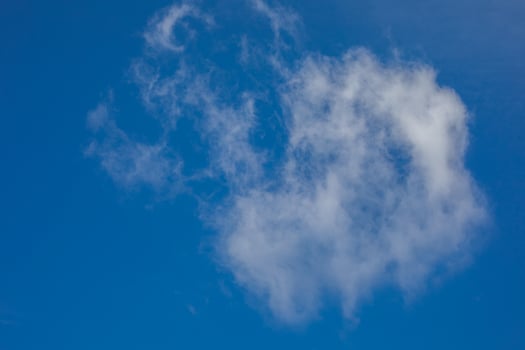 Fluffy cloud whispering cryptic tales in cobalt sky, reminiscent of Dream Day contemplation and World Cloud Appreciation photo