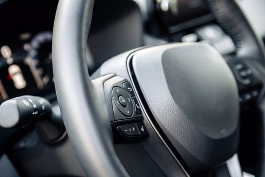 Close-up of a car steering wheel in a modern new car. The interior of a stylish new car. Concept of stylish design photo