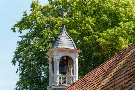 A clock tower with a bell on top of it photo
