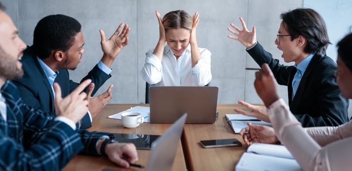 Conflict At Work. Businessmen Shouting At Unhappy Victimized Businesswoman Coworker Sitting At Desk In Modern Office. Disagreement, Business Team Communication Problems Concept photo