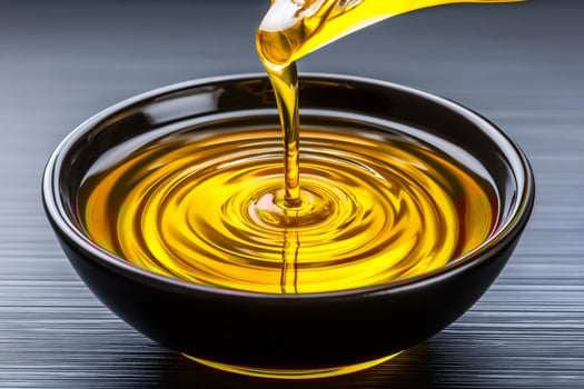 Golden liquid pouring into a bowl, creating concentric ripples photo