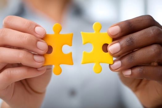 Business people joining two matching puzzle pieces photo