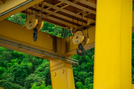 30-ton crane hook installed on hydroelectric dam. Lifting electric equipment, repairing turbines, and managing water flow. Maintenance operations. Construction, engineering, and industrial safety. photo