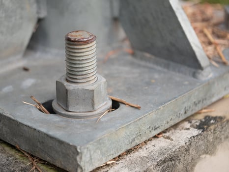 Industrial action close-up of rusty bolt on metal base construction site detailed image urban environment macro perspective photo