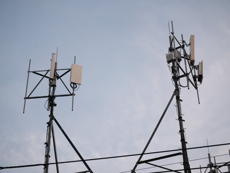 Telecommunication towers in urban sky technology infrastructure industrial setting evening light modern connectivity concept photo