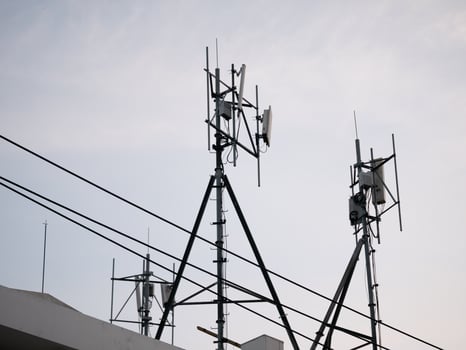 Telecommunication infrastructure installation urban setting photography clear sky perspective technology advancement photo