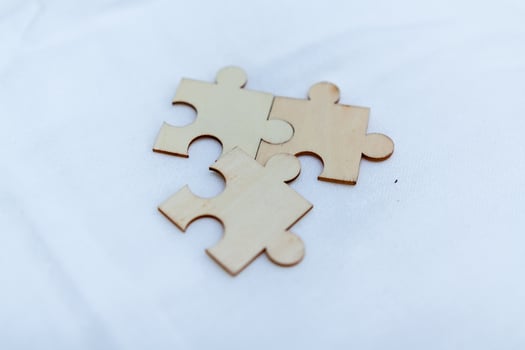 Strategic business collaboration puzzle pieces representing teamwork modern office visual content professional environment close-up view problem-solving concept photo