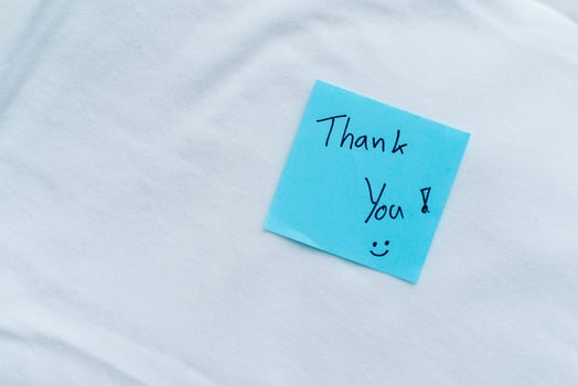 Gratitude in business thank you note on white fabric close-up inspirational calm environment personal touch photo