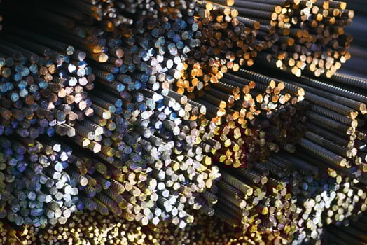 Steel rods stacked in an industrial storage facility photo