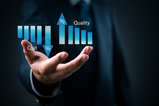 A man in a suit is holding a bar graph with the words quality and cost photo