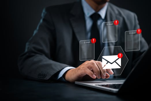 Businessman using laptop with email icons on screen photo