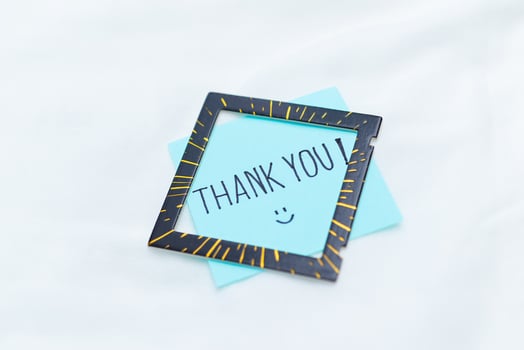 Thank you note and frame home office visual communication minimalist environment close-up view business appreciation concept photo