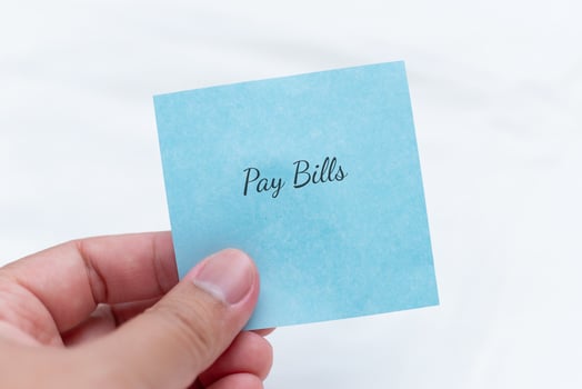 Reminder note to pay bills by hand home office visual reminder calm environment personal finance concept photo