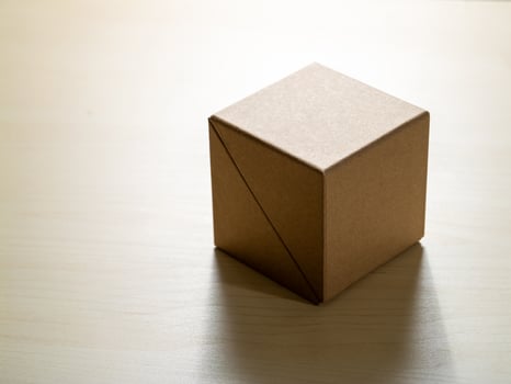Unpacking creativity cardboard box on wooden table minimalist setting still life photo