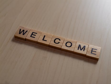Warm welcome sign made of wooden tiles in cozy indoor environment for home decor inspiration photo