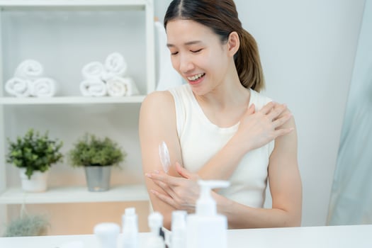 Beautiful Asian woman smile use cream for good skin. healthy woman apply cream for body. Advertisement for skin cream, anti-wrinkle, baby face, whitening, moisturizer, tighten pores serum. photo