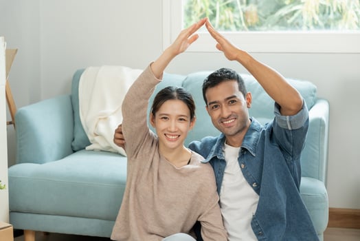 Moving house, relocation, Couple show identify of home on new house, inside the room was a cardboard box contain personal belongings. move in the new apartment or condominium. photo