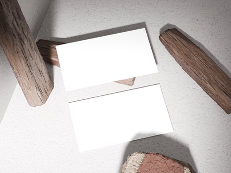 Business card placed on a stone surface with wooden logs, giving an earthy and natural feel. photo