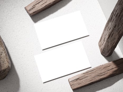 Simple business card on a stone block with wooden logs placed creatively for a unique design. photo