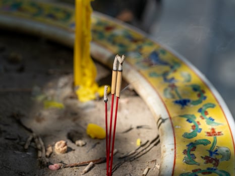 Ceremonial incense and spiritual reflection in tranquil temple grounds and cultural rituals photo